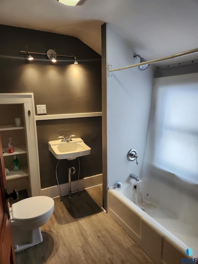 full bathroom featuring bathtub / shower combination, wood-type flooring, toilet, and sink