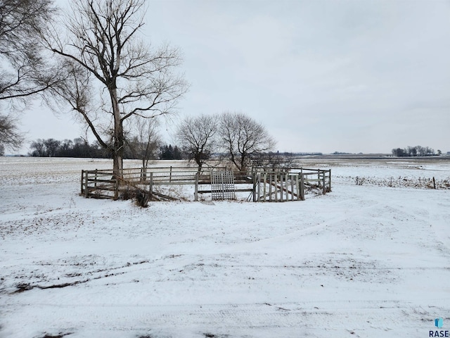 yard layered in snow featuring a rural view