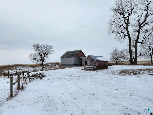 yard covered in snow featuring an outdoor structure