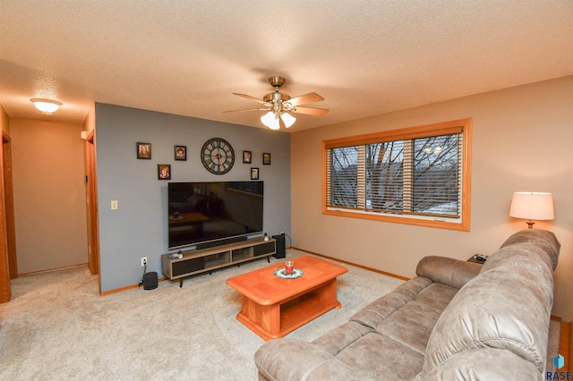 carpeted living room featuring a textured ceiling and ceiling fan