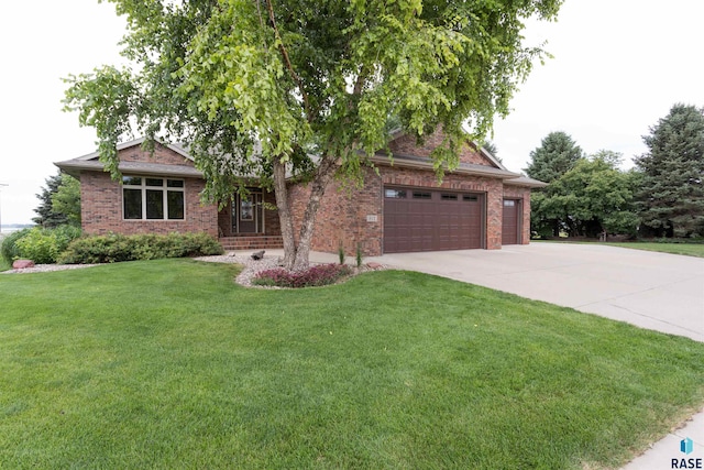 view of front of home with a garage and a front lawn