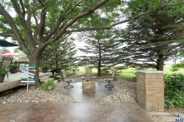 view of patio with a wooden deck and an outdoor fire pit