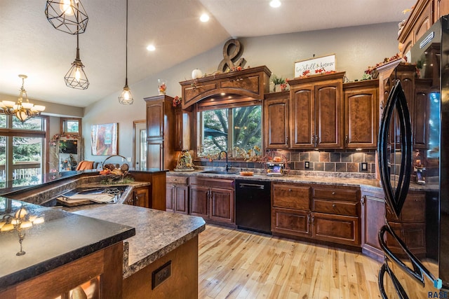 kitchen with vaulted ceiling, decorative light fixtures, sink, light hardwood / wood-style floors, and black appliances