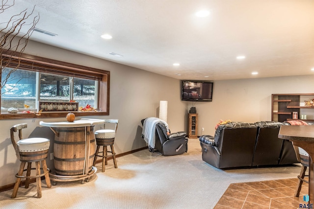 living room featuring bar and light carpet