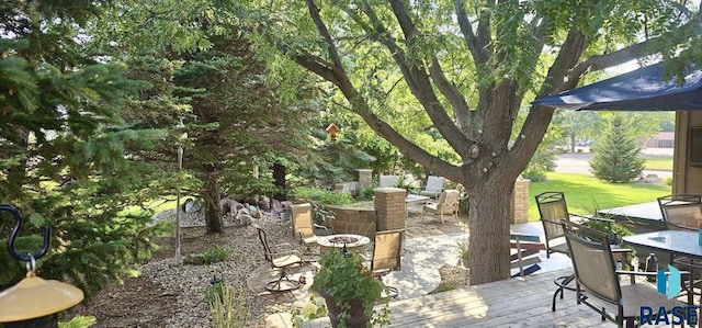 wooden terrace featuring an outdoor fire pit