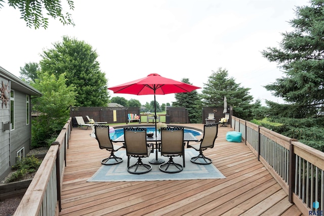 wooden terrace featuring a fenced in pool