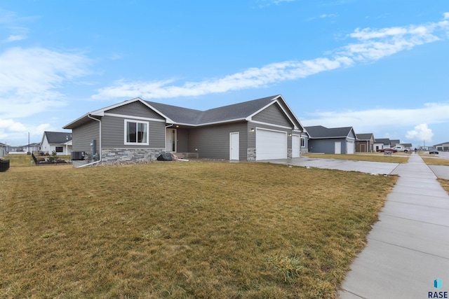 single story home with a front yard, central AC, and a garage