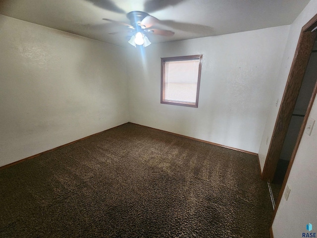 spare room featuring ceiling fan and carpet