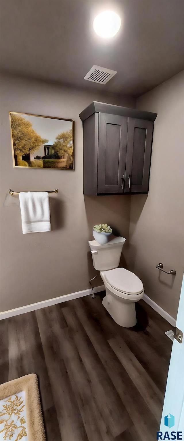 bathroom with hardwood / wood-style floors and toilet