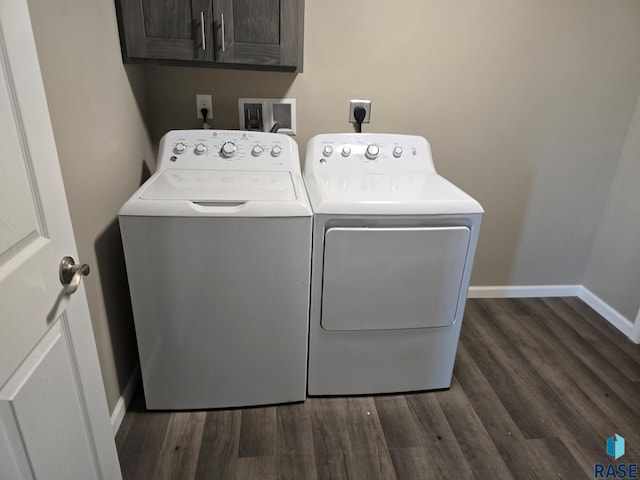 laundry area with cabinets, dark hardwood / wood-style floors, and washer and dryer