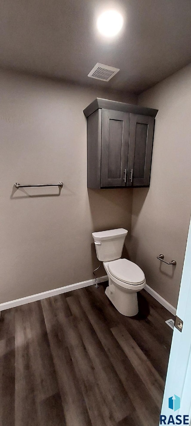 bathroom featuring hardwood / wood-style floors and toilet