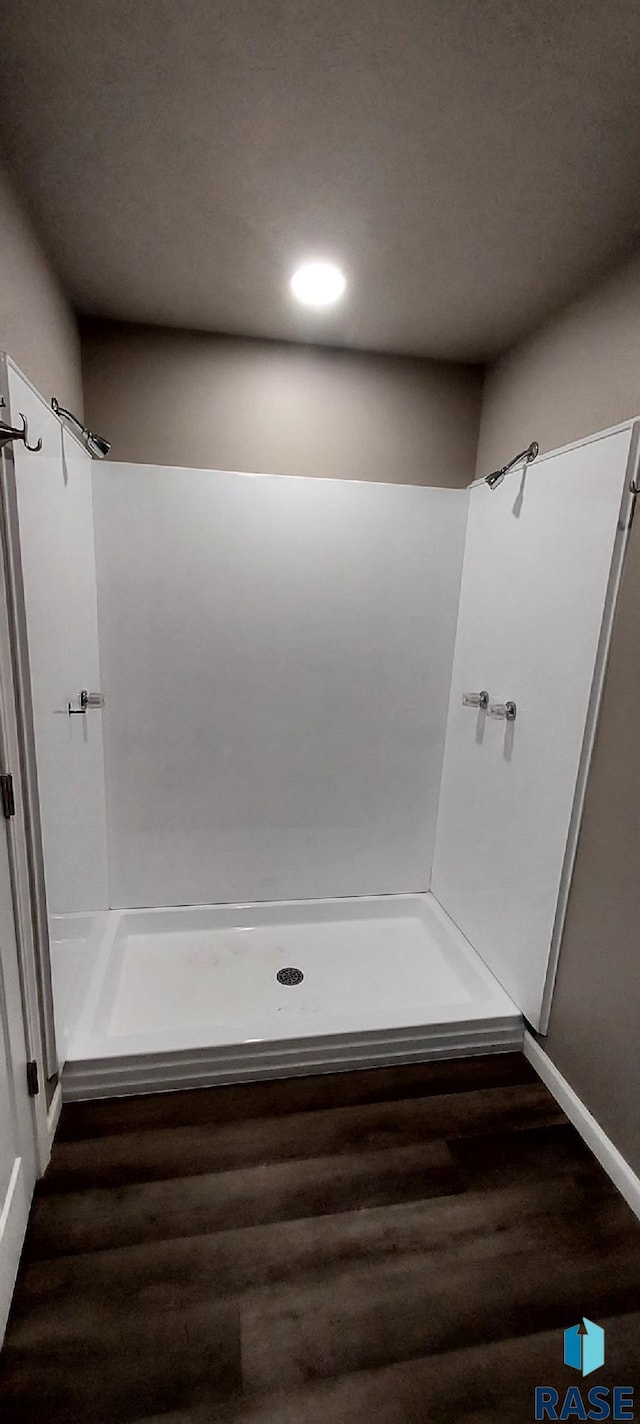 bathroom featuring a shower and hardwood / wood-style flooring