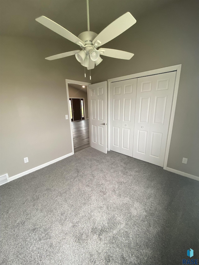 unfurnished bedroom with carpet, ceiling fan, and a closet