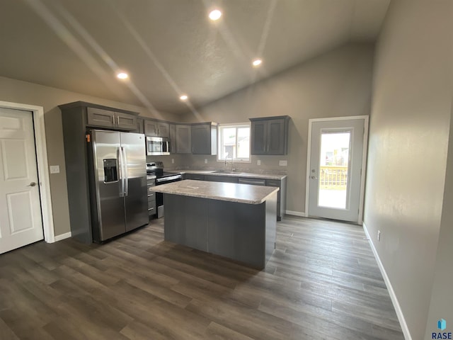 kitchen featuring gray cabinets, stainless steel appliances, a kitchen island, and plenty of natural light