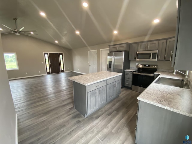 kitchen featuring appliances with stainless steel finishes, a kitchen island, ceiling fan, and gray cabinetry