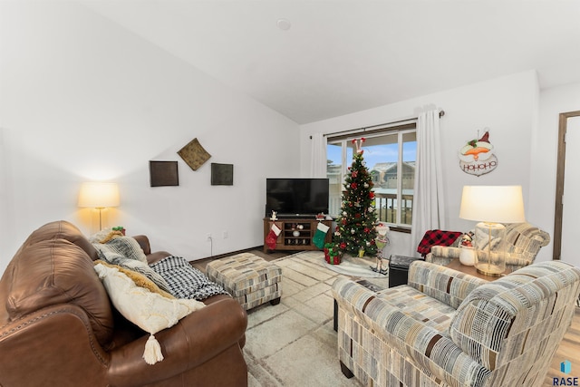 living room with light hardwood / wood-style floors and lofted ceiling