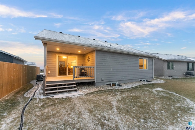 back house at dusk featuring a deck and central air condition unit