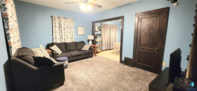 carpeted living room with ceiling fan