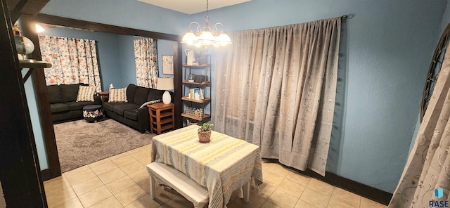 carpeted dining space featuring an inviting chandelier