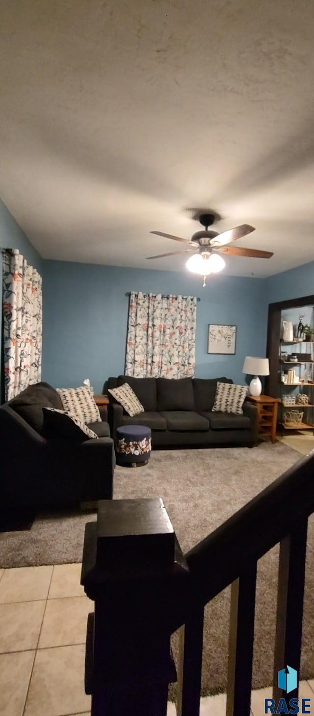 tiled living room featuring ceiling fan