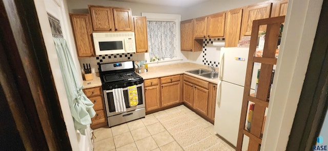 kitchen with white appliances, sink, decorative backsplash, and light tile patterned floors