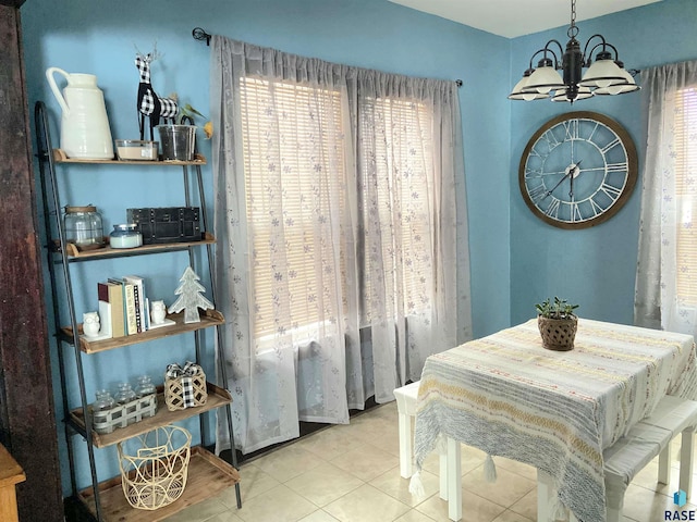 dining space featuring tile patterned flooring, a wealth of natural light, and a chandelier