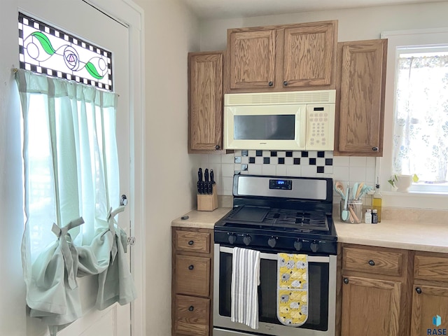 kitchen with stainless steel range with gas cooktop and backsplash