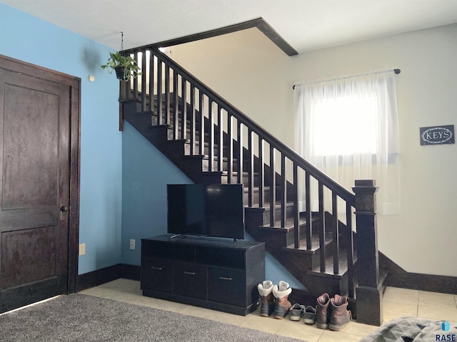 stairway with tile patterned floors