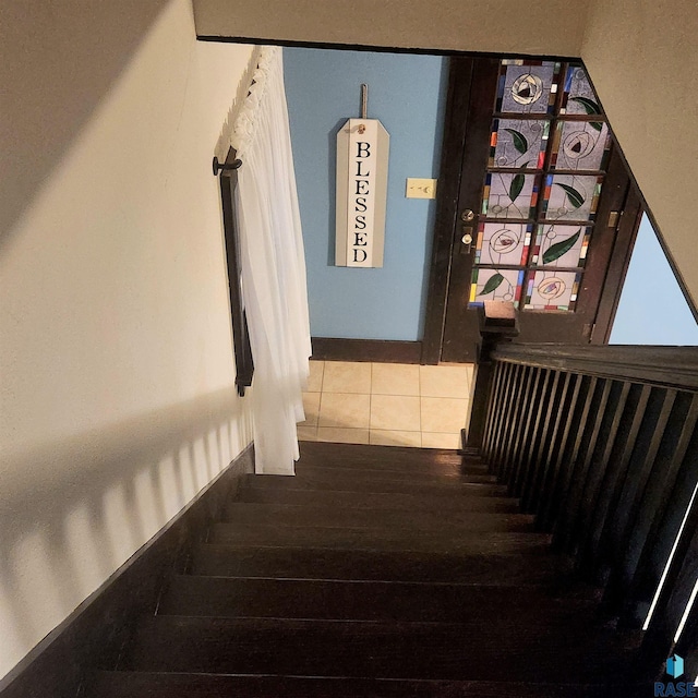 staircase featuring tile patterned flooring