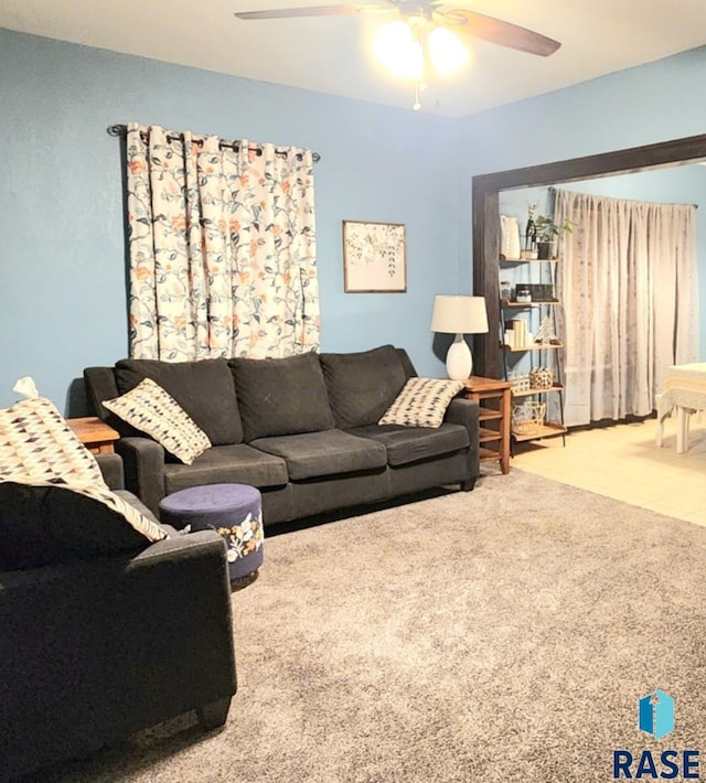 living room featuring carpet flooring and ceiling fan