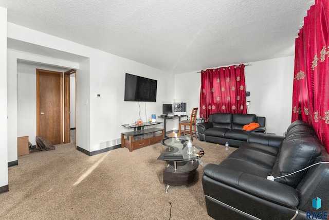 carpeted living room featuring a textured ceiling