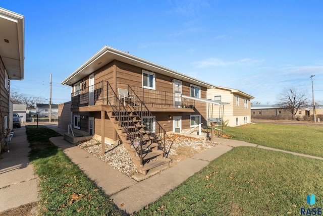 back of property with a lawn and a deck