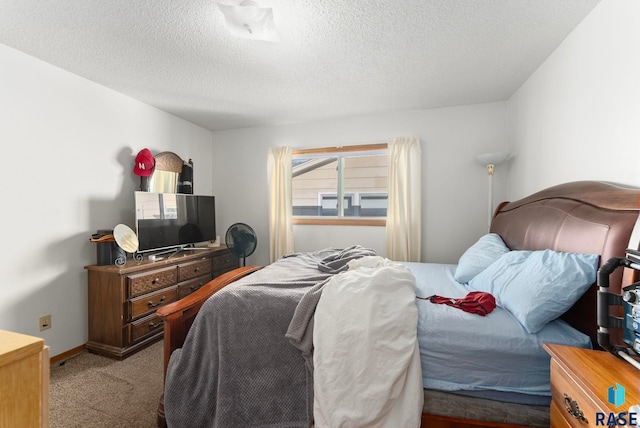 bedroom featuring a textured ceiling and light colored carpet