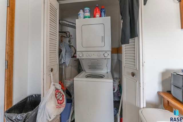 laundry room featuring stacked washer / drying machine