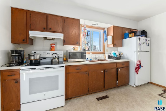 kitchen featuring white appliances and sink