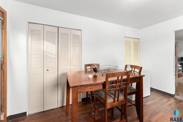 dining area with dark hardwood / wood-style floors