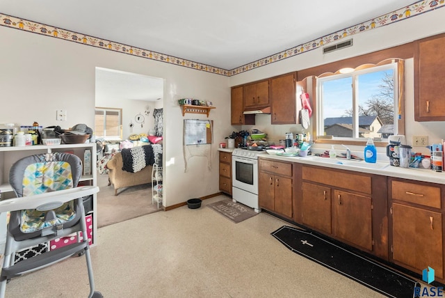 kitchen featuring white range and sink