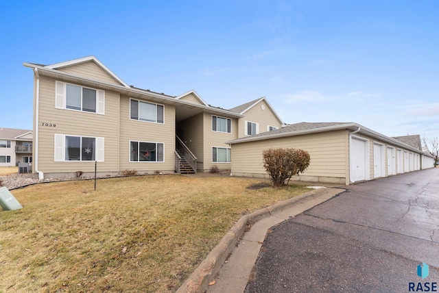 view of front of property featuring a garage and a front lawn