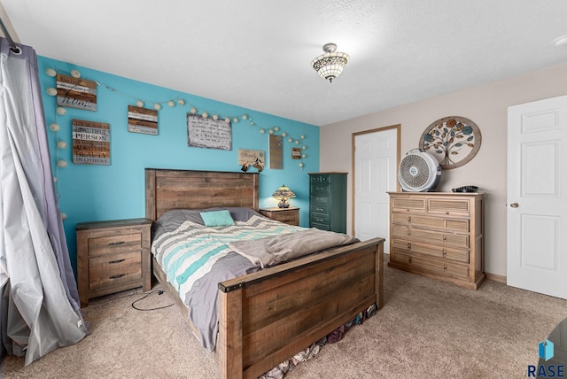 carpeted bedroom featuring a textured ceiling