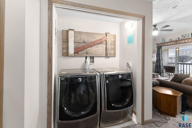 laundry area with a textured ceiling, washing machine and dryer, light colored carpet, and ceiling fan