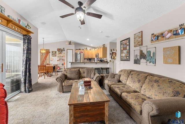 carpeted living room with a healthy amount of sunlight, ceiling fan with notable chandelier, a textured ceiling, and lofted ceiling