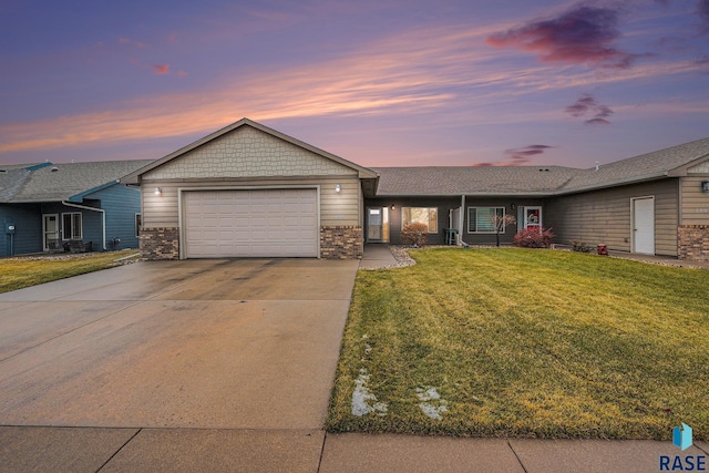 single story home with a lawn and a garage