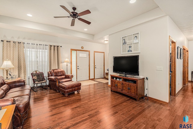 living room featuring hardwood / wood-style floors and ceiling fan