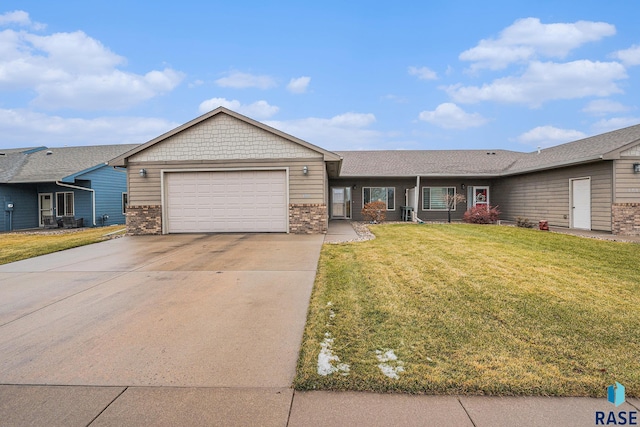 single story home featuring a garage and a front lawn