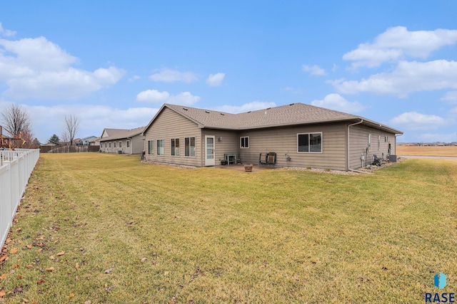 back of property with a yard and a patio area