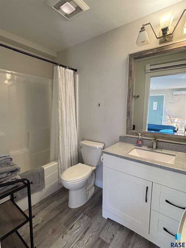 full bathroom featuring shower / tub combo with curtain, vanity, wood-type flooring, and toilet