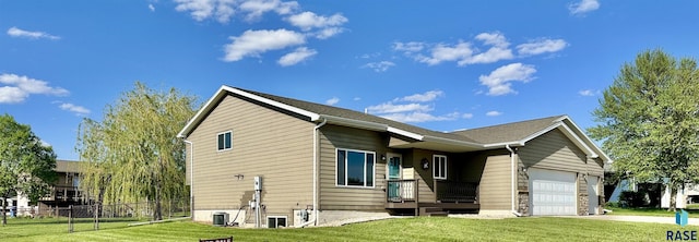 view of side of property with a yard and a garage