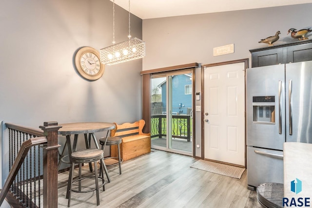 interior space featuring hardwood / wood-style floors and high vaulted ceiling