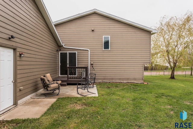 back of property featuring a lawn and a patio