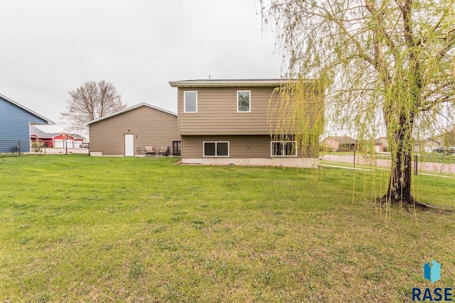 rear view of property with a lawn